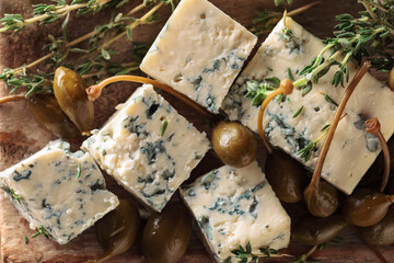 Blue cheese , capers and branches of thyme.