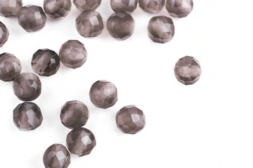 Beads made of natural rauchtopaz agate on a white background are isolated