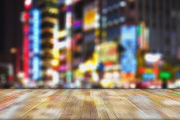 Blurred images of bokeh light and renown night life background montage photo with wooden top table for product display