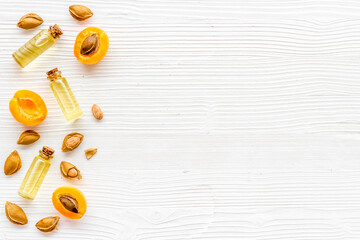 Bottles of apricot kernel oil with ripe apricot fruits