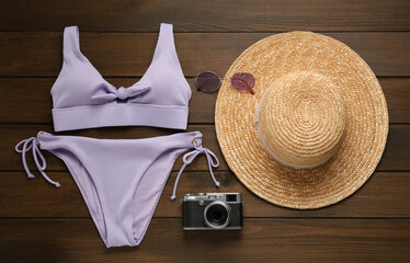 Different beach objects on wooden background, flat lay