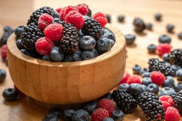 Food healthy blueberry berry organic. vegetarian. Blueberries, raspberries, blackberries in a wooden bowl.