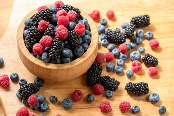 Food healthy blueberry berry organic. blue juicy. Blueberries, raspberries, blackberries in a wooden bowl.