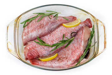 Ocean perch carcasses prepared for baking in baking dish, top view