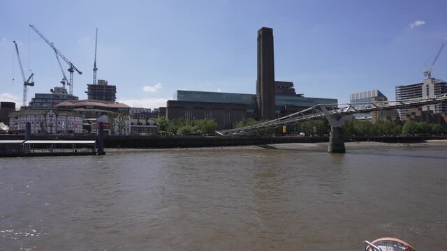 The Millennium Bridge and Tate Gallery from onboard River Thames cruise boat, London