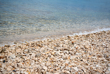 Small pebbles on the seashore. Pebble sea beach.