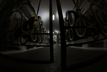 Wine barrels are stored at the factory in the basement