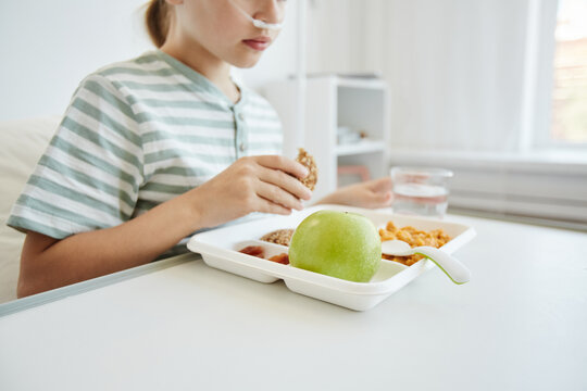Cropped Shot Of Girl Eating Healthy Lunch In White Hospital Room, Background With Copy Space