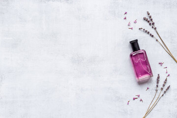 Fototapeta premium Perfume bottle with aroma flowers and leaves