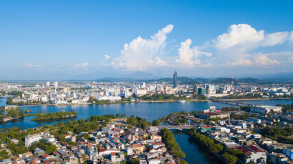 city, landscape, village, mountain, river, building, pagoda, church, field, park, school, market, lagoon, citadel, bridge, museum, hill, pass, beach, calm, hotel, lake, water, sky, nature, clouds