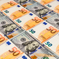 Dollars and euros, confrontation and domination, influence, world currencies close up.