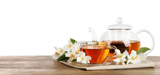 Aromatic jasmine tea and fresh flowers on wooden table against white background. Space for text