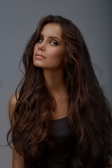 Fototapeta premium Portrait of a young beautiful woman. Long hair. A tan. Healthy skin. The beauty.