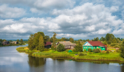 Fototapeta na wymiar Traditional Russian village in the north of Russia on the river bank in summer
