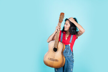 Obraz premium singer with acoustic guitar. music and art. musical shop. happy girl enjoy the moment. Have Fun on Celebration. woman singing with guitar. young hipster playing on guitar