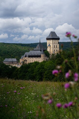 Fototapeta na wymiar Karlstejn Castle, historical building of the Czech Republic in the summer blooming scenery. Popular tourist destination/attraction near Prague.