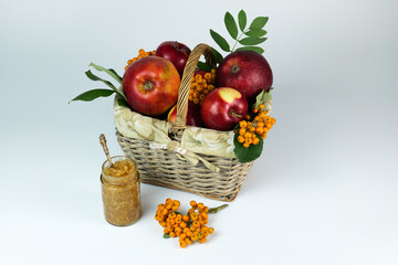 Apples in the basket with Apple jam and Rowanberry on the white background