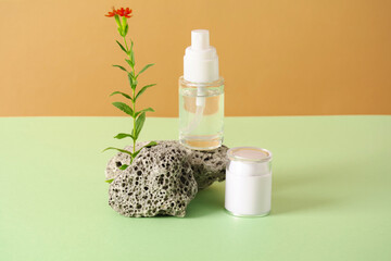 Obraz na płótnie Canvas Cosmetic bottle with gel or other cosmetic product, stones and flower. Natural organic cosmetic, healthy beauty concept.