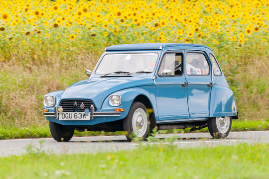 Vintage Citroen 2CV in front of a field with blooming sunflowers on August 12, 2016