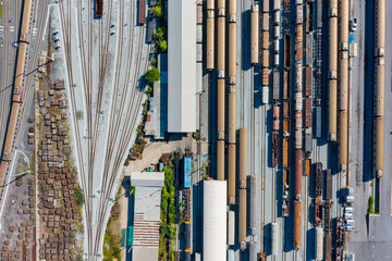 Obraz premium Aerial top view Passenger and freight trains on the railway station for transportation background. wagons with goods on railroad.