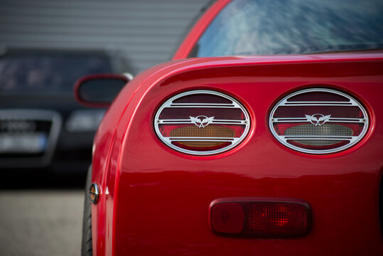 Mulhouse - France - 8 August 2021 - Closeup of rear light of red chevrolet corvette parked in the street