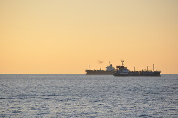 Shipping ships on the sea at sunset