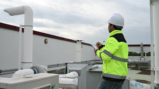 Air conditioning technicians repair and maintain condensing units outside the building, engineers inspect the operation of ventilation fans.