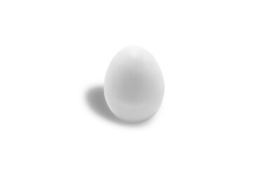Isolated white chicken egg close-up on a white background. Free space. Minimalism. Tone to tone.