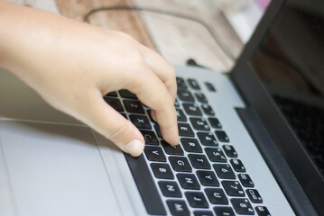 Top view, woman's hands typing work, on tablet keyboard at home close-up, blurred background