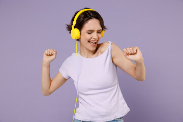 Young fun smiling joyful cool happy woman 20s with bob haircut wear white t-shirt yellow headphones...