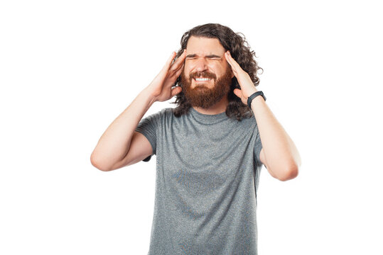 Photo of man heaving headache over white background, frustrated man