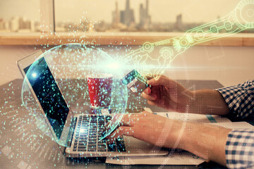 Double exposure of man hands holding a credit card and data theme drawing. E-commerce and technology concept.