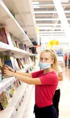 Teenage girl choosing stationery for school in   store