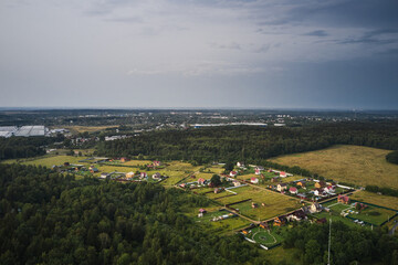 Fototapeta premium Small village with country road at summer, view from above