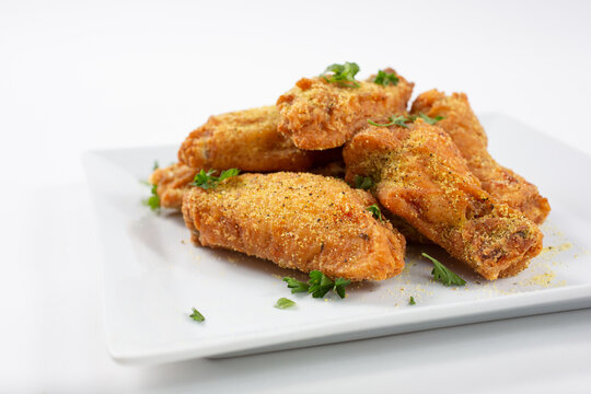 A view of a plate of lemon pepper rub chicken wings.