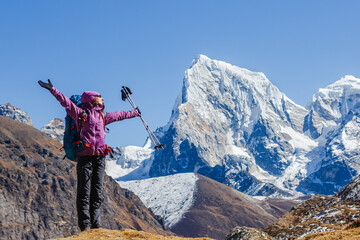 Hiking in Himalaya mountains. Woman Traveler with Backpack hiking in the Mountains. Travel sport lifestyle concept