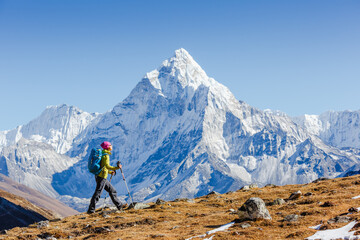 Happy hiker walking in the mountains. Himalayas, Everest Base Camp trek, Nepal - obrazy, fototapety, plakaty