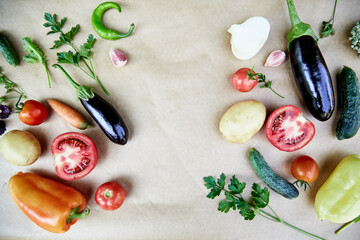 Fototapeta na wymiar Vegetable frame: beet, basil, eggplant, parsley, bell pepper, hot pepper, potatoes, cucumber, carrots. Italian vegetable recipe. Veganism concept food.Top view, copy space