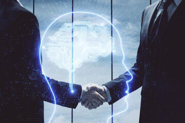Double exposure of brain hologram and handshake of two men. Partnership in IT industry concept.