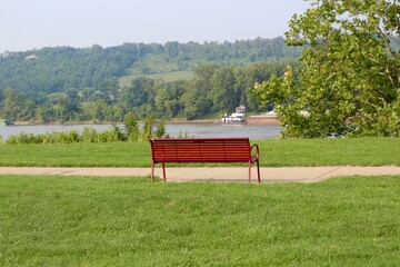 The red park bench overlooking the river.