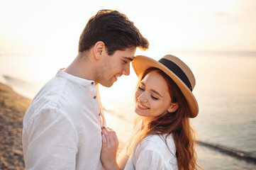 Obraz premium Close up profile smiling happy young lovely couple two friends family man woman in casual clothes hugging together at sunrise over sea beach ocean outdoor exotic seaside in summer day sunset evening.