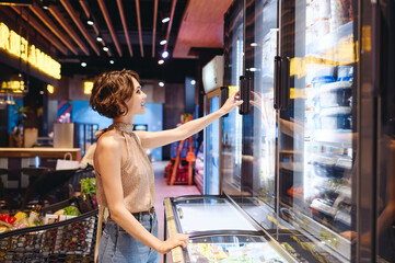 Young happy woman in casual clothes shopping at supermaket greengrocery store buy choosing dairy...