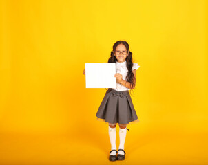 a beautiful happy dark-skinned schoolgirl girl with dark hair wearing glasses in a school uniform a...