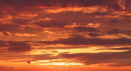 Naklejka na ściany i meble Beautiful orange fiery sunset in the sky, natural background 