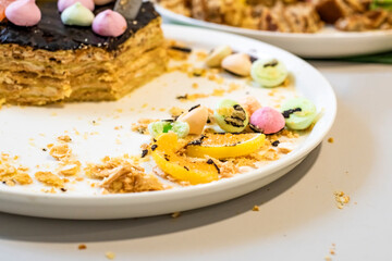 Different types of sweets from the cake are on the saucer.