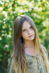 Fototapeta premium beautiful attractive stylish girl in a green dress, with long hair romantic mood, posing in summer fashion style, natural look