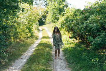 beautiful attractive stylish girl in a green dress, with long hair romantic mood, posing in summer fashion style, natural look