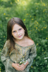 beautiful attractive stylish girl in green dress holding flower, romantic mood, posing in summer fashion style, natural look