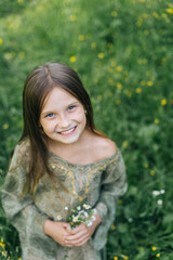 beautiful attractive stylish girl in green dress holding flower, romantic mood, posing in summer...