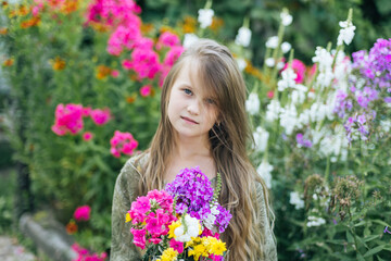 beautiful attractive stylish girl in green dress holding flower, romantic mood, posing in summer fashion style, natural look